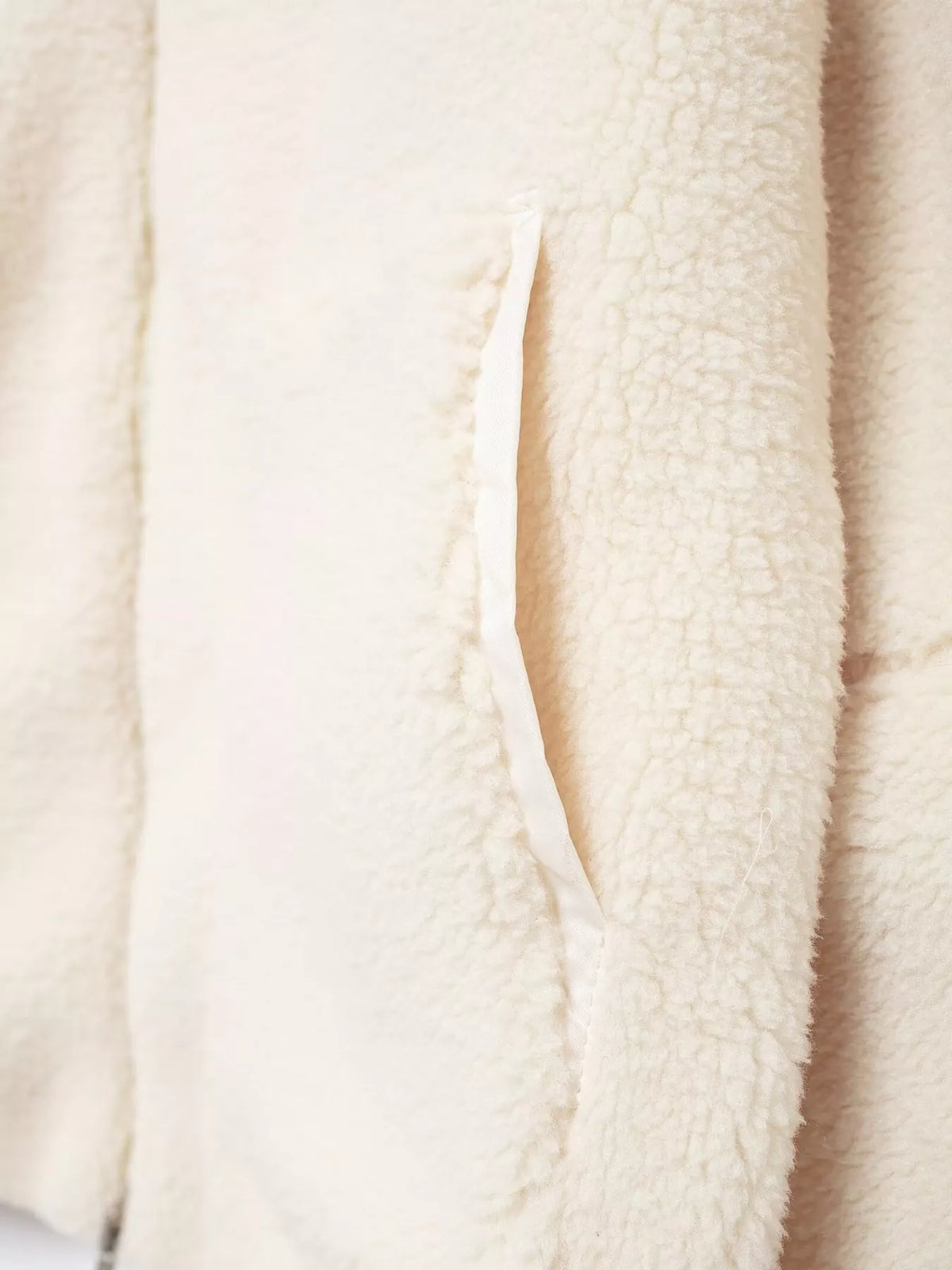 Cream sherpa zip-up jacket, close-up of patch pocket opening