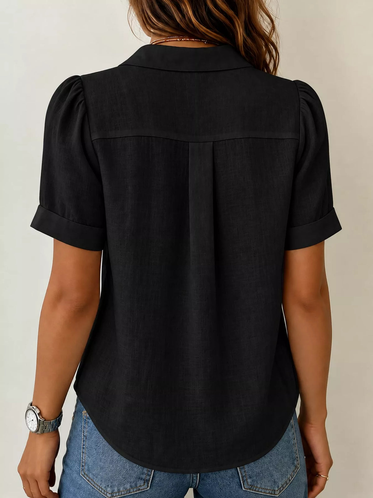 Black button up short sleeve shirt, back view
