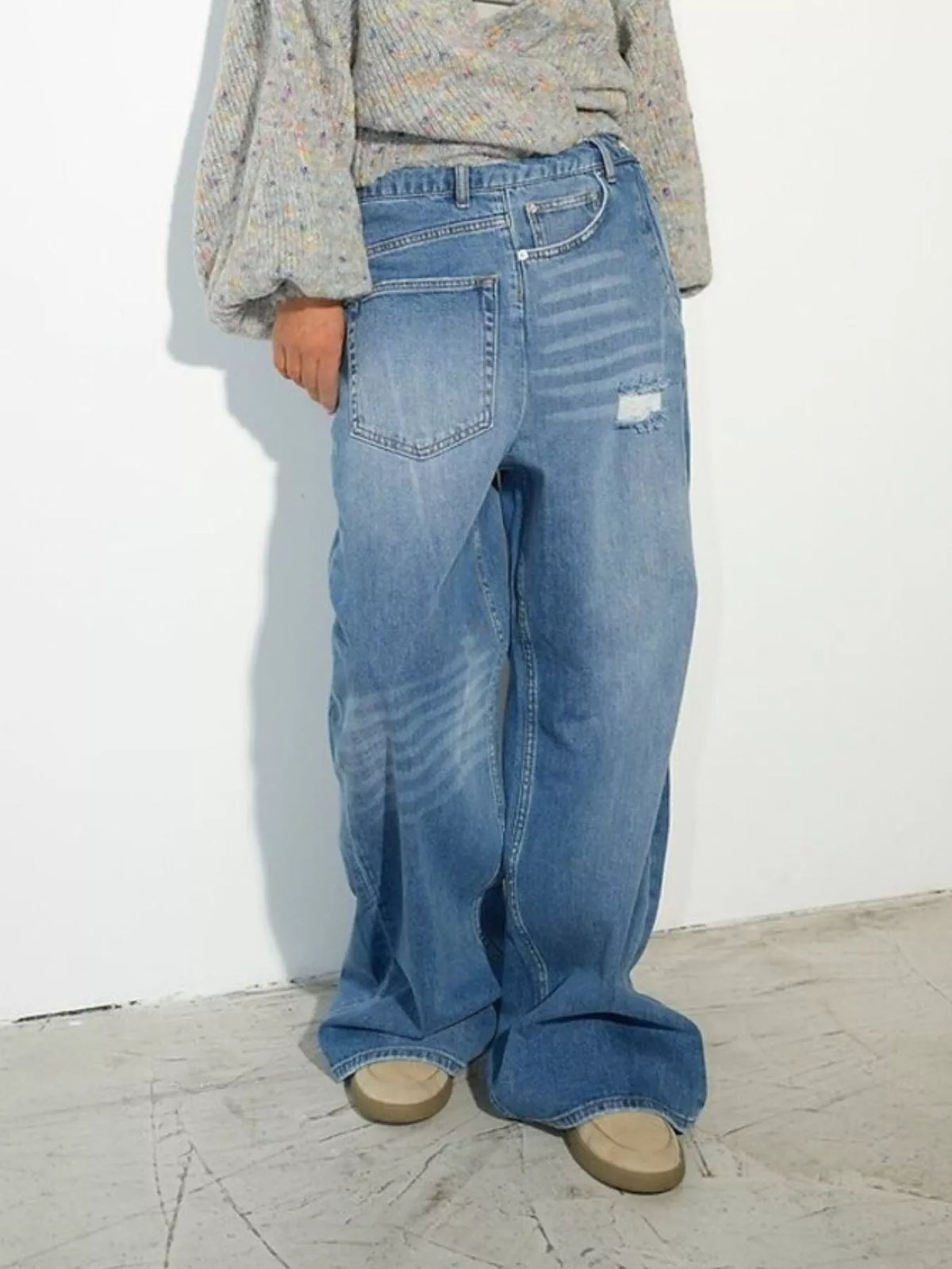Blue high-waisted distressed wide-leg jeans, full front view.