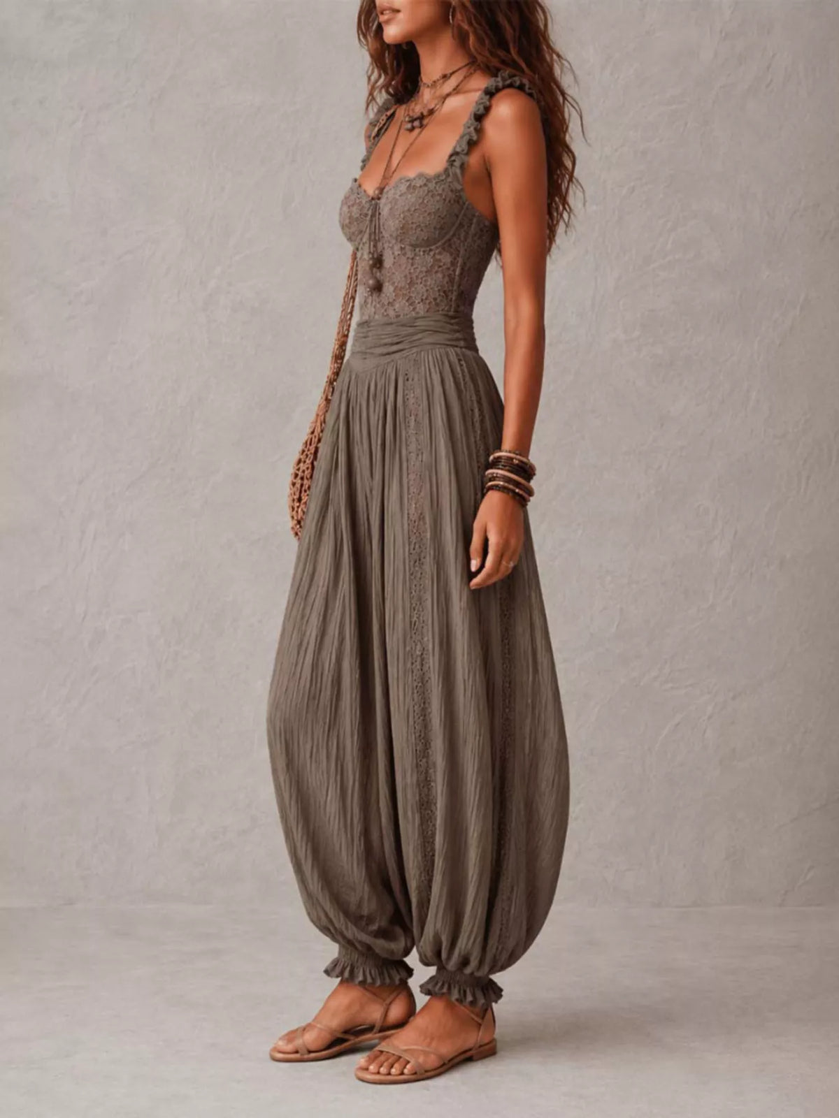 Taupe lace-bodice harem-leg jumpsuit, side view.