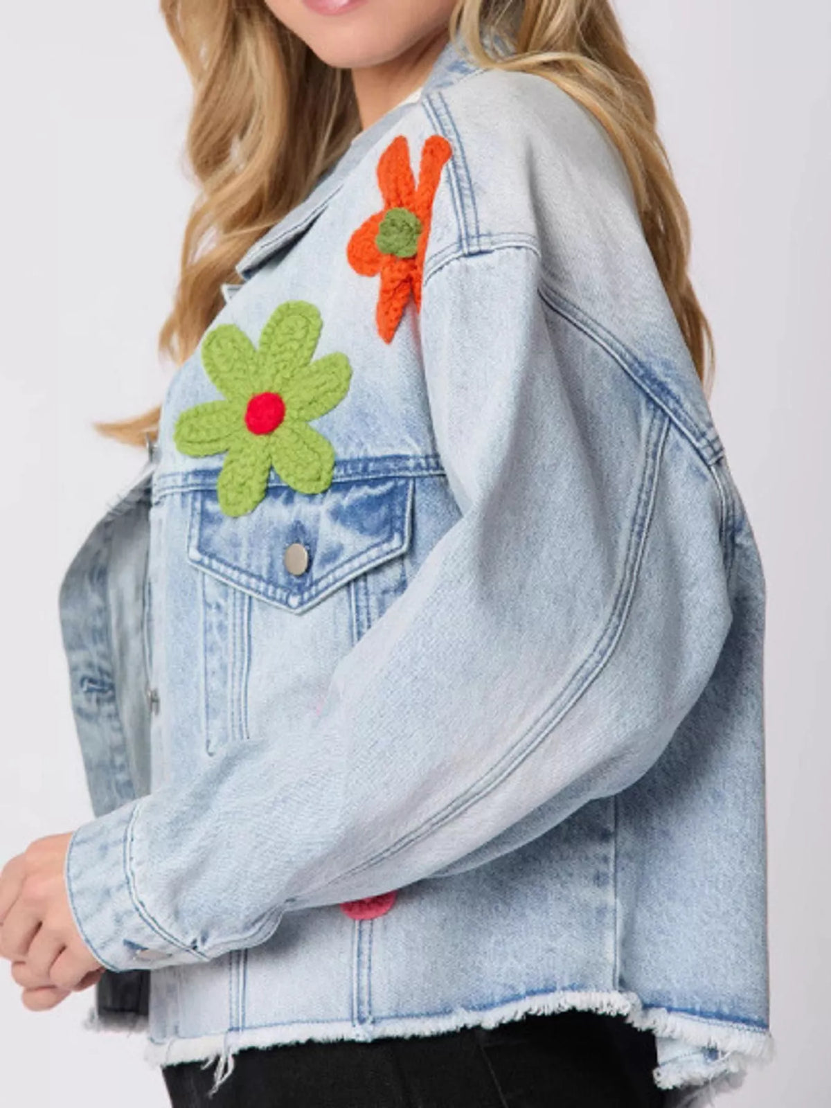 Light blue applique cropped denim jacket with raw hem, detail view