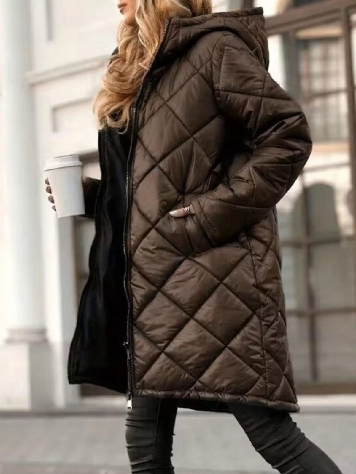 Brown hooded longline quilted puffer coat, angled front view showing pocket.
