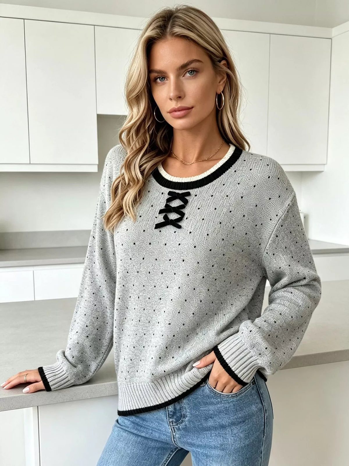 Gray and black polka dot lace-up sweater, front view showing contrasting cuffs.
