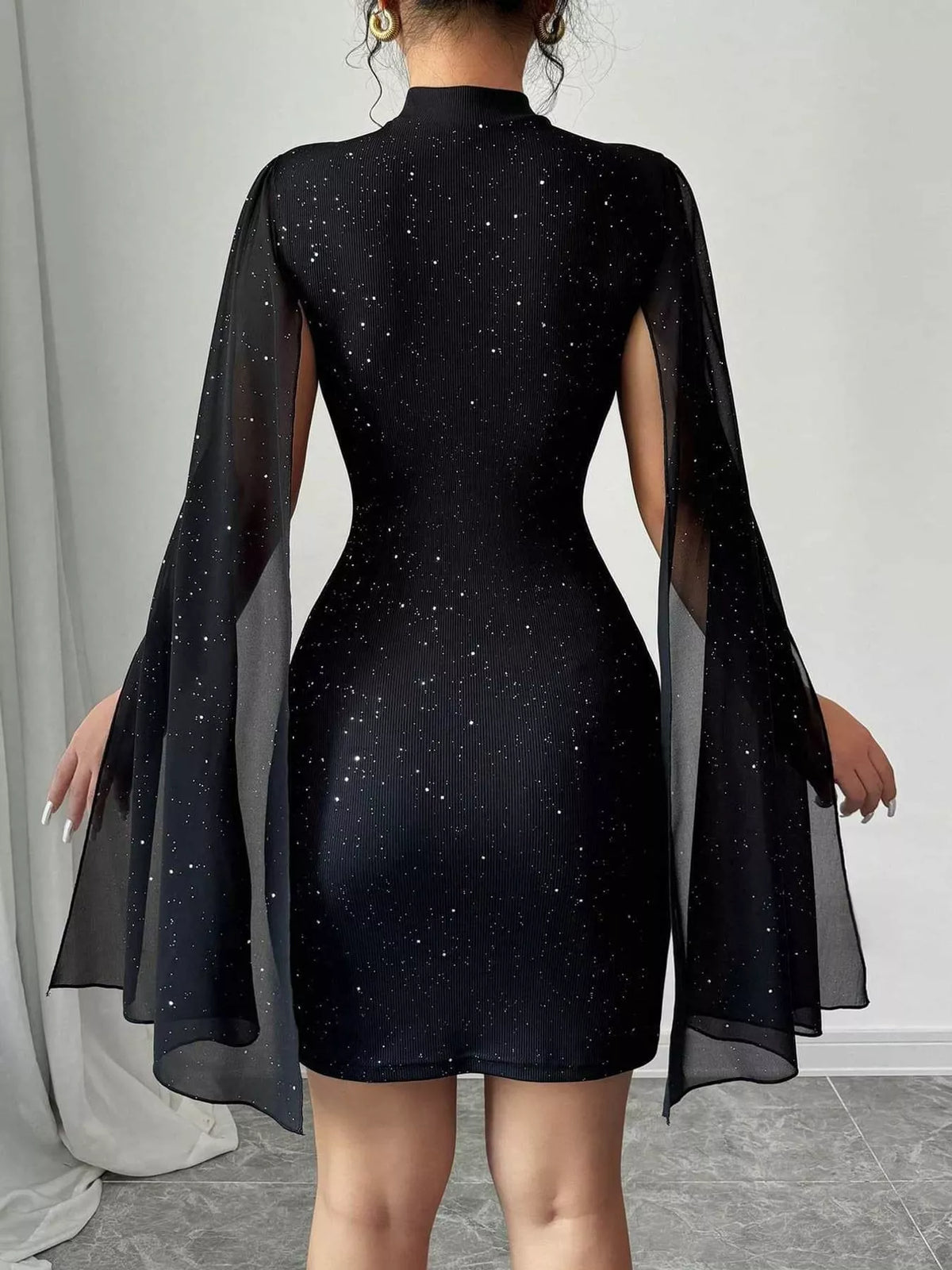 Black glitter mock neck cape-sleeve mini dress — back view