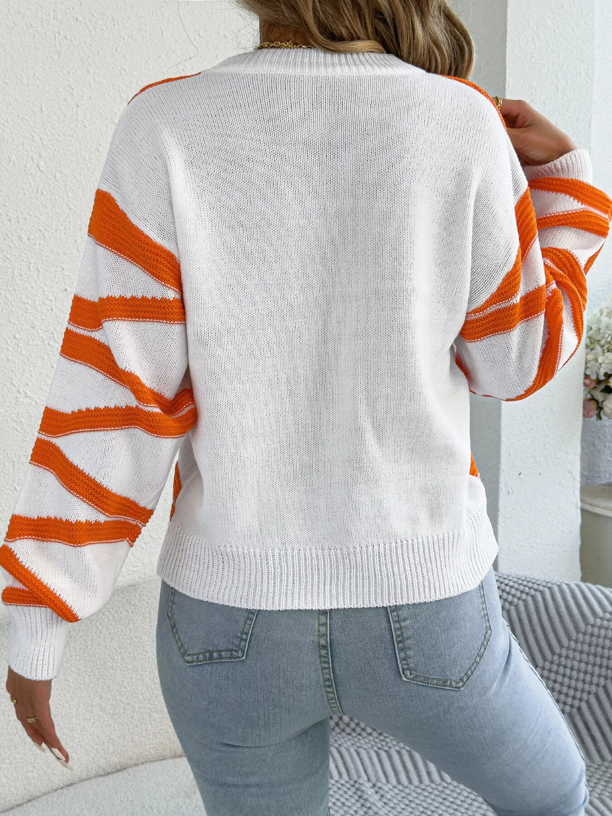 Orange striped crew neck sweater, back view