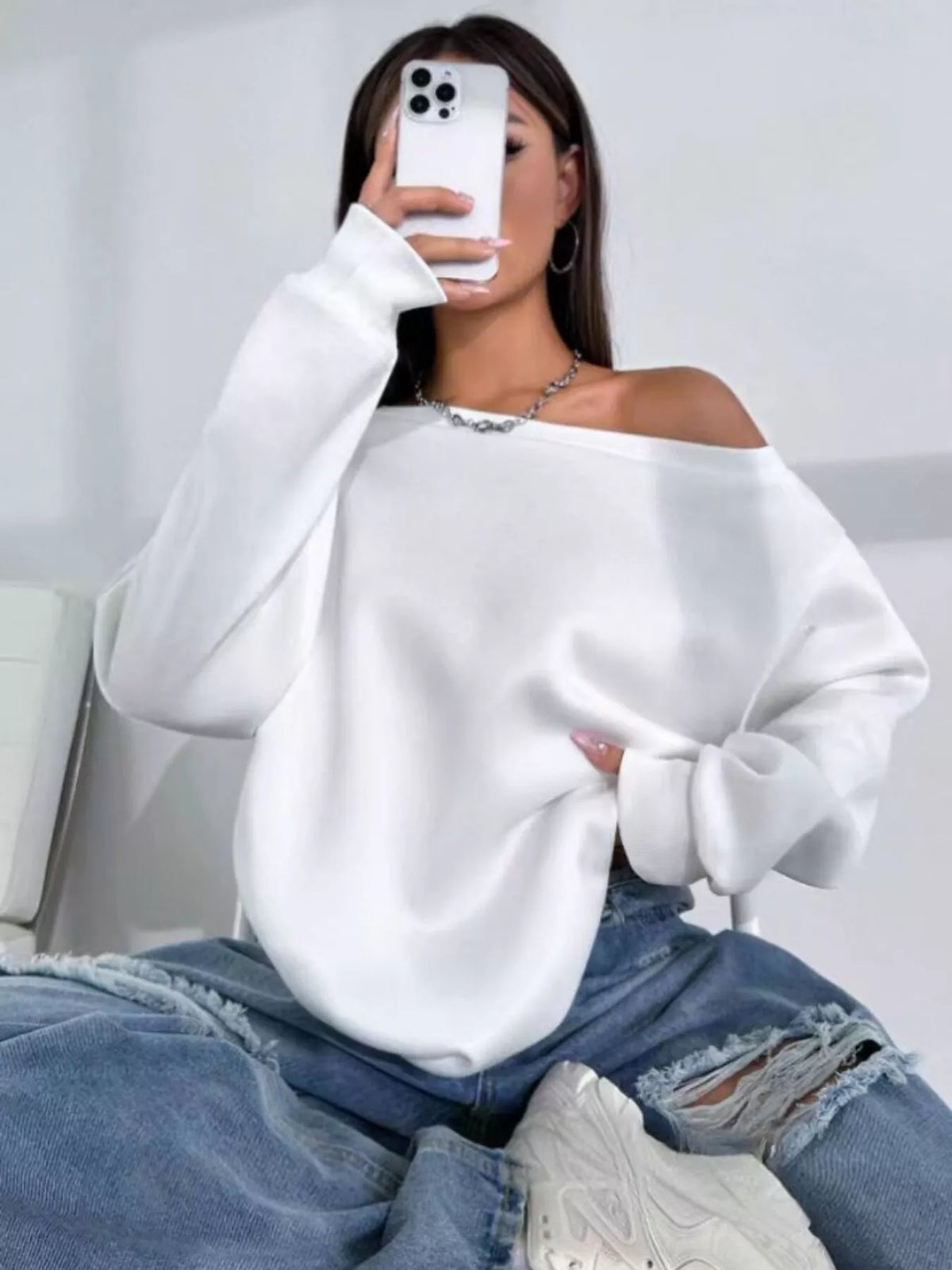 White asymmetric-neck sweatshirt, seated front view