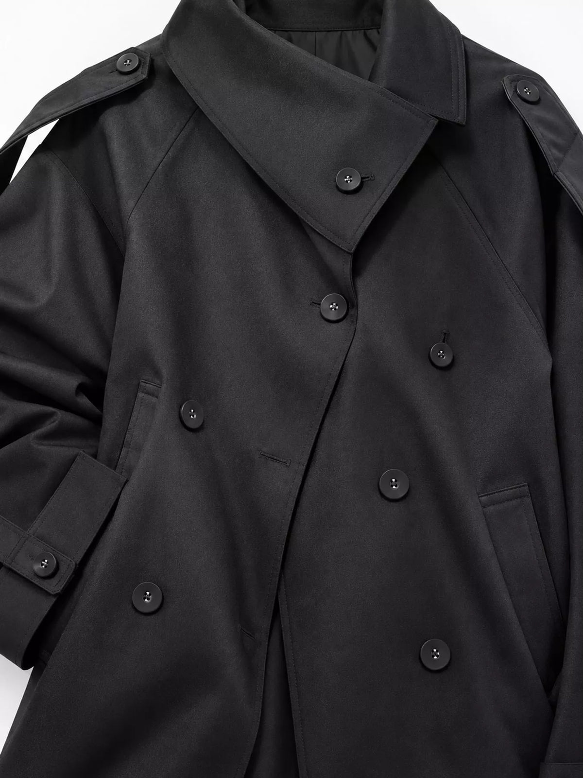 Black double-breasted cropped trench jacket, collar and shoulder detail