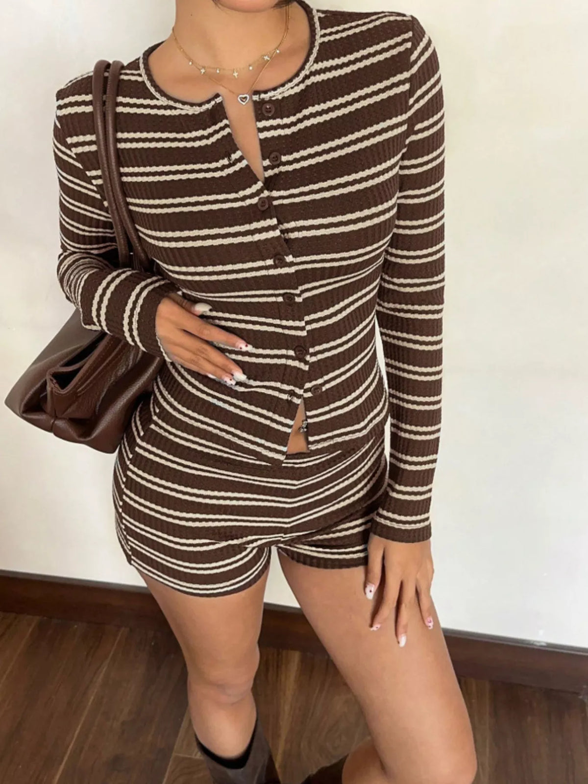 Striped cardigan and shorts set in brown and cream, angled front view