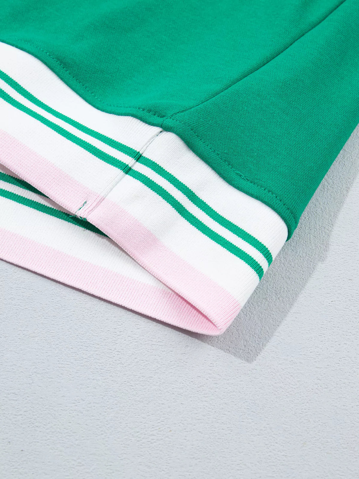 Green sweatshirt with contrast striped ribbed trim, hem detail