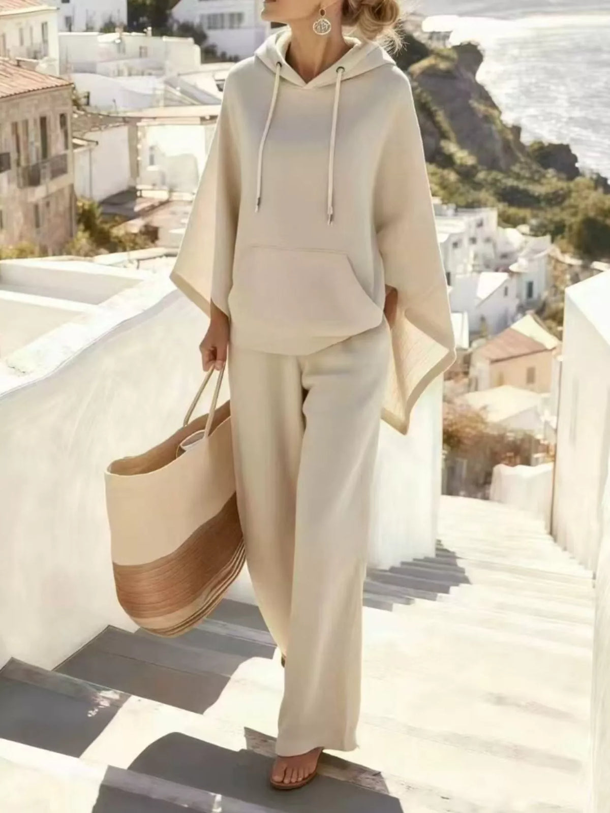 Cream hooded poncho and wide-leg pants set, full front view.