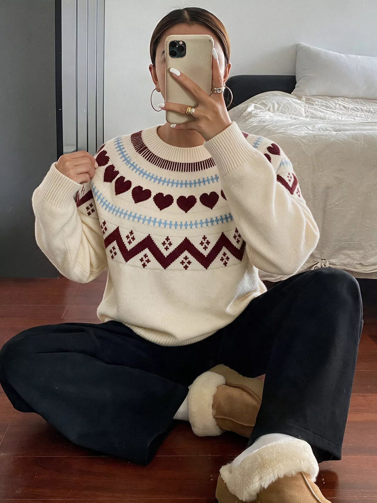 Cream heart-patterned crew neck sweater, seated view
