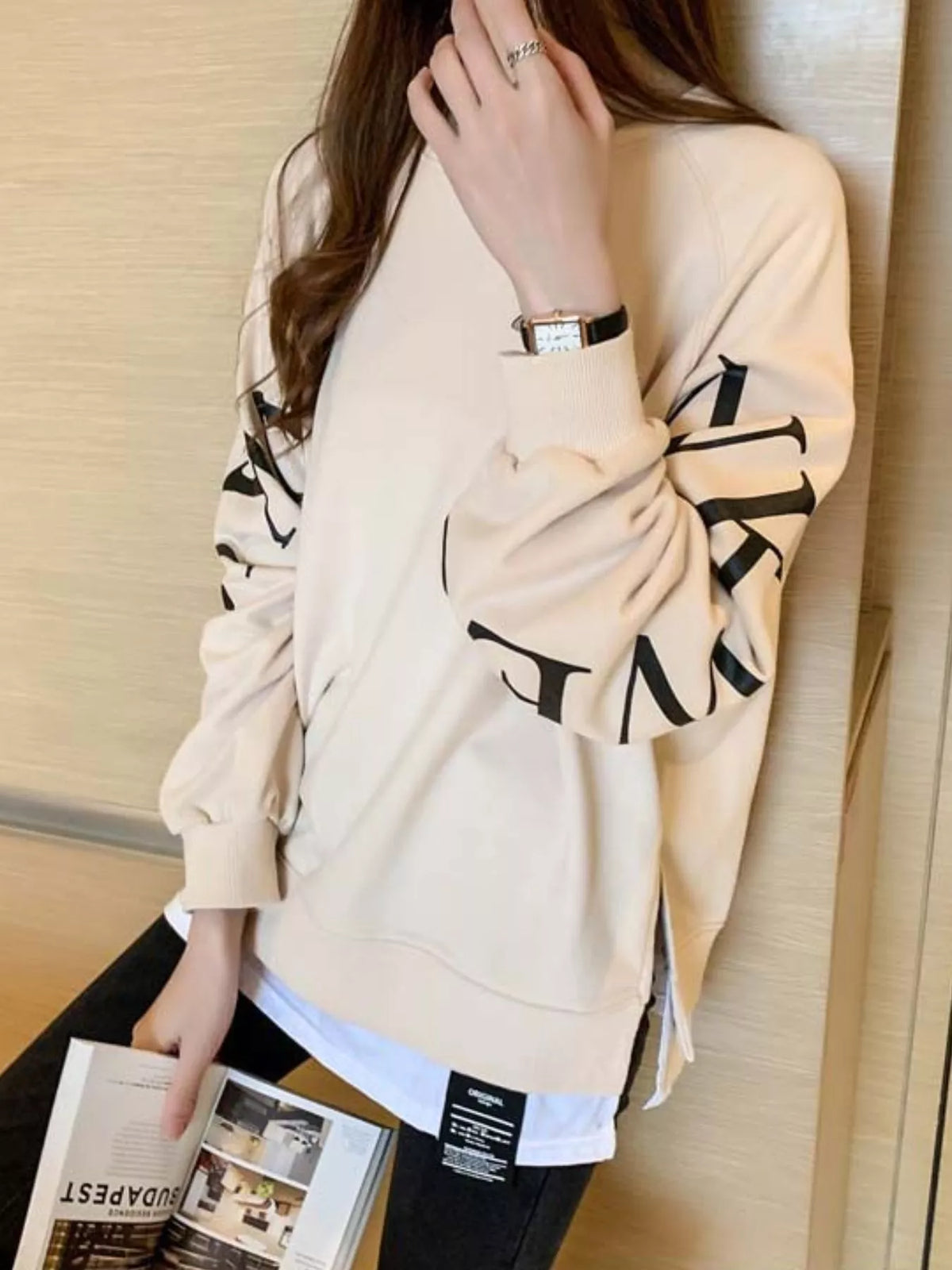 Apricot layered-hem sweatshirt with graphic sleeve detail