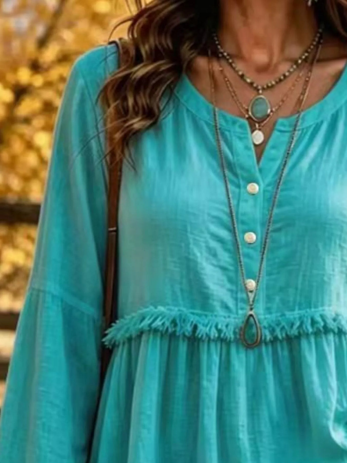Turquoise fringed button detail blouse, split neckline, front buttons, and frayed waist seam