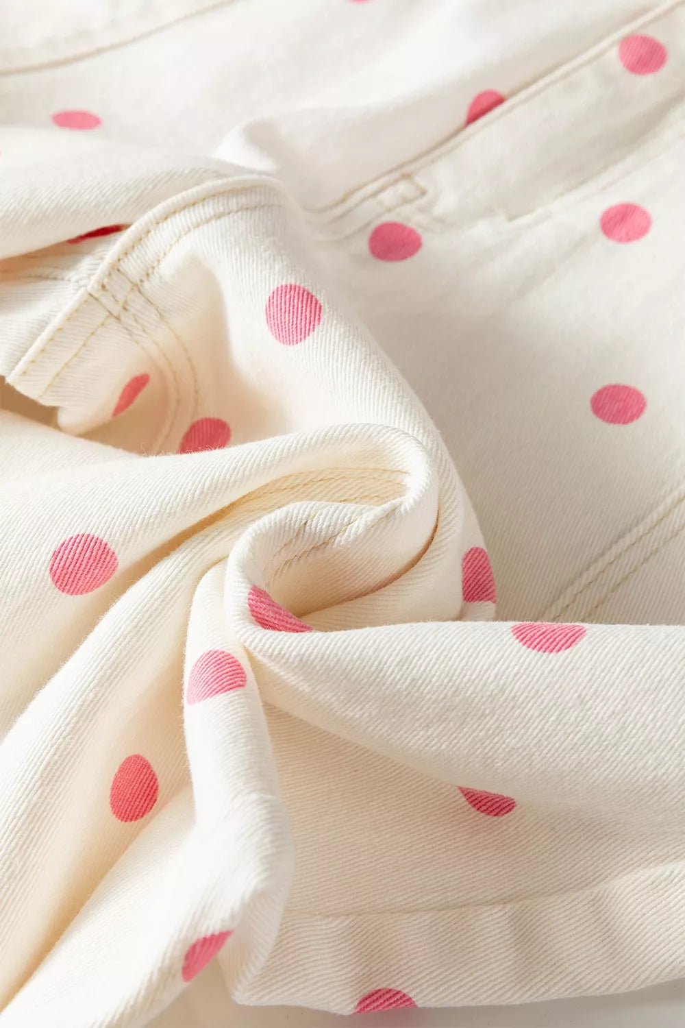White with pink dots polka-dot cropped jeans, fabric and dot print close-up
