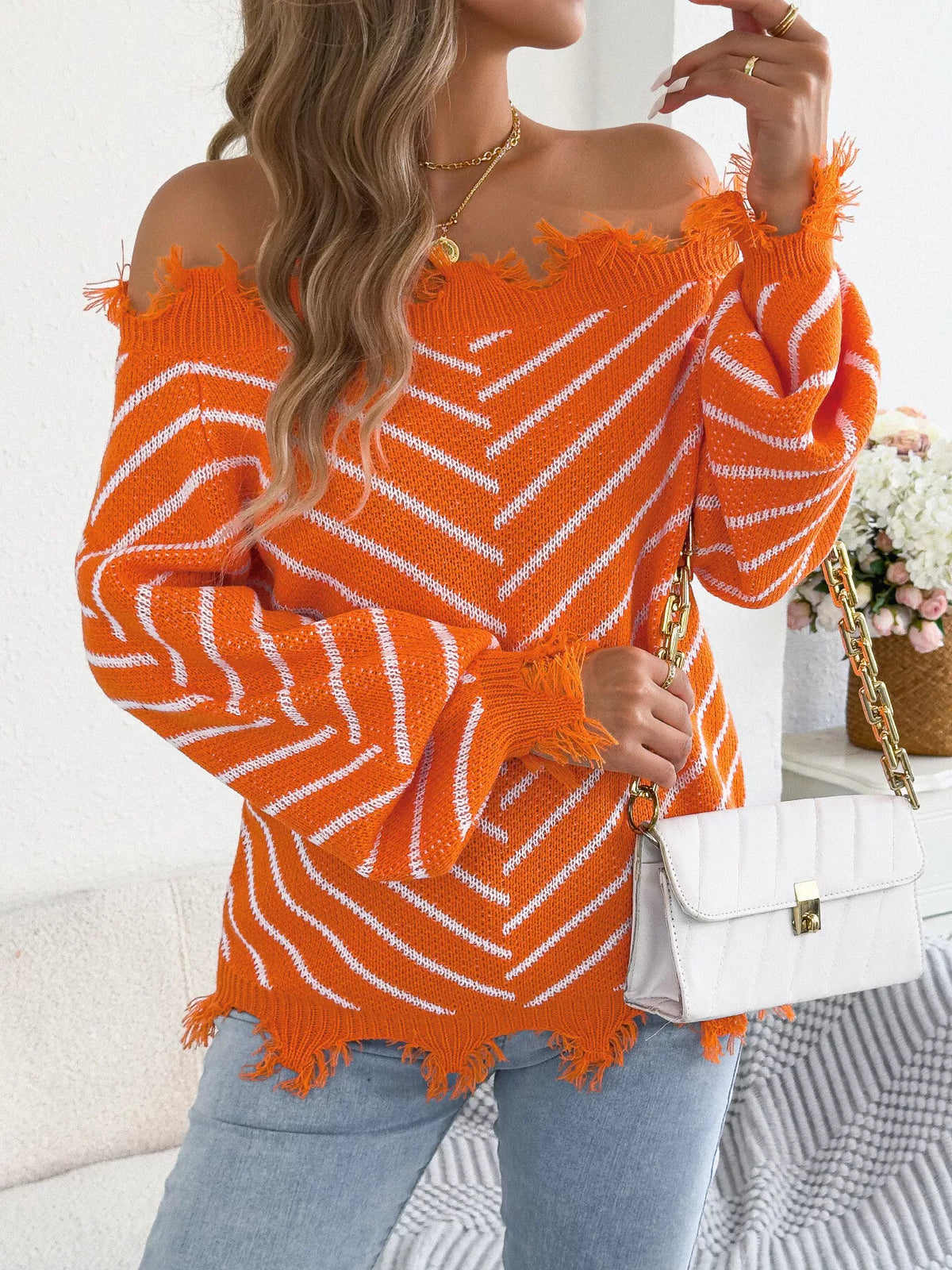 Orange off-shoulder distressed striped sweater