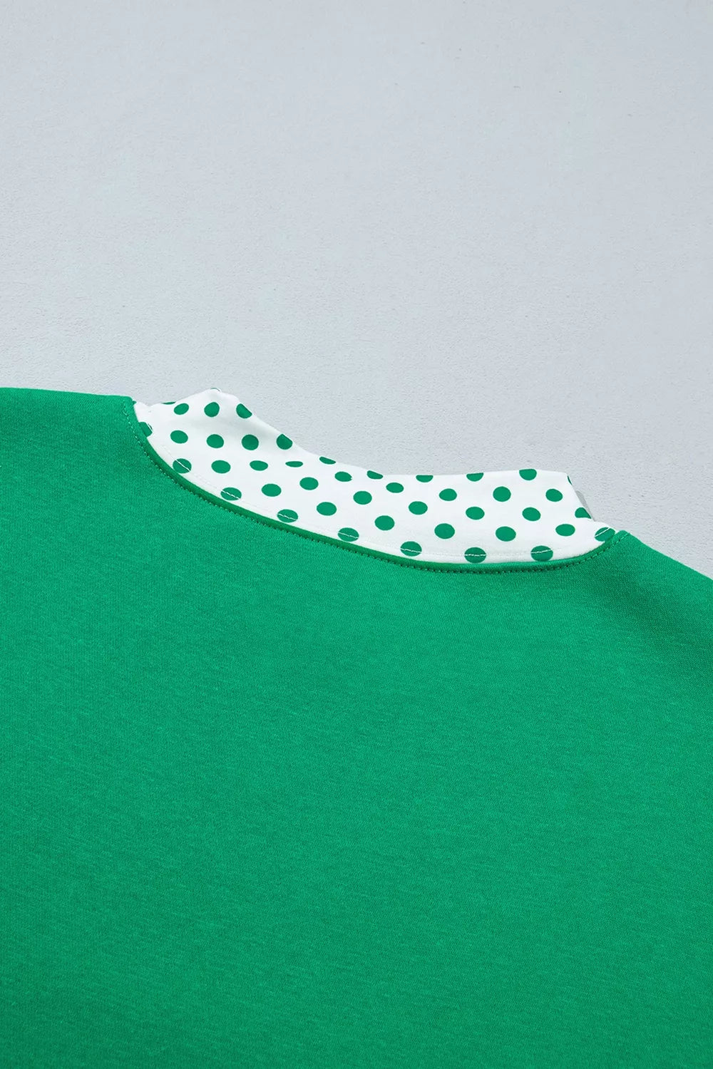 Green sweatshirt and shorts set with polka-dot trim, back neckline detail