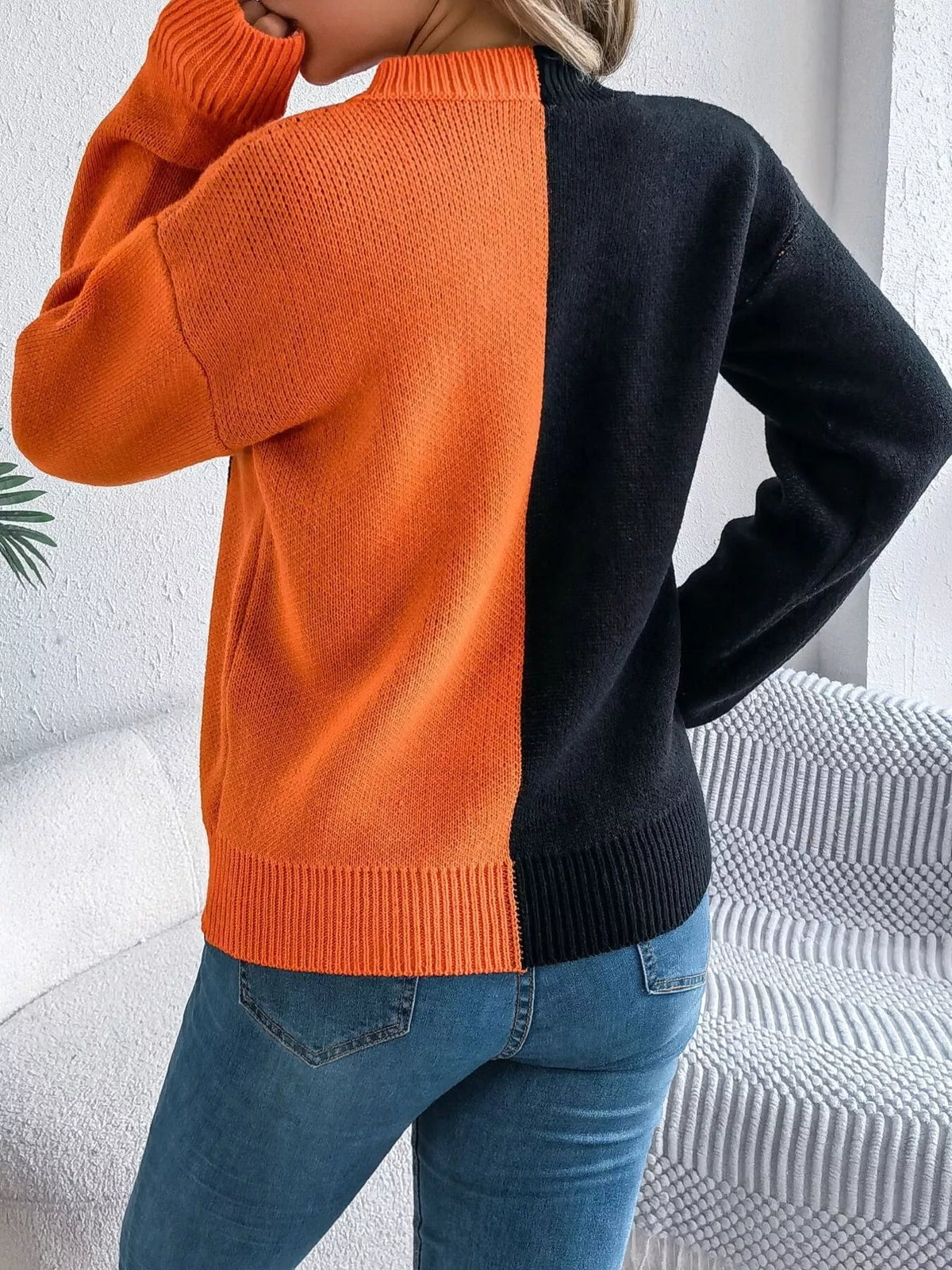 Pumpkin Face Graphic Two Tone Sweater in orange and black, back view