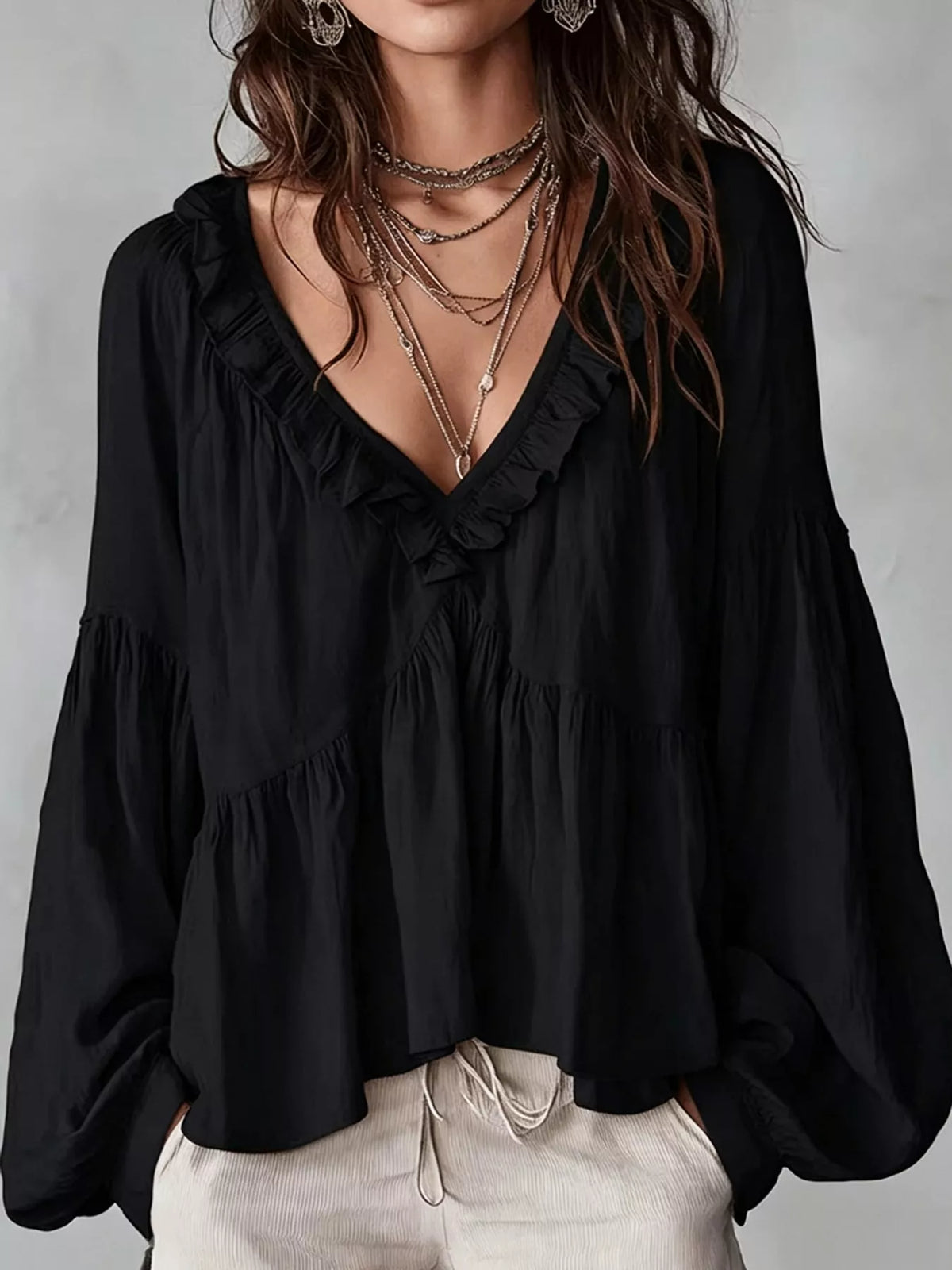 Black ruffled v neck blouse, front view