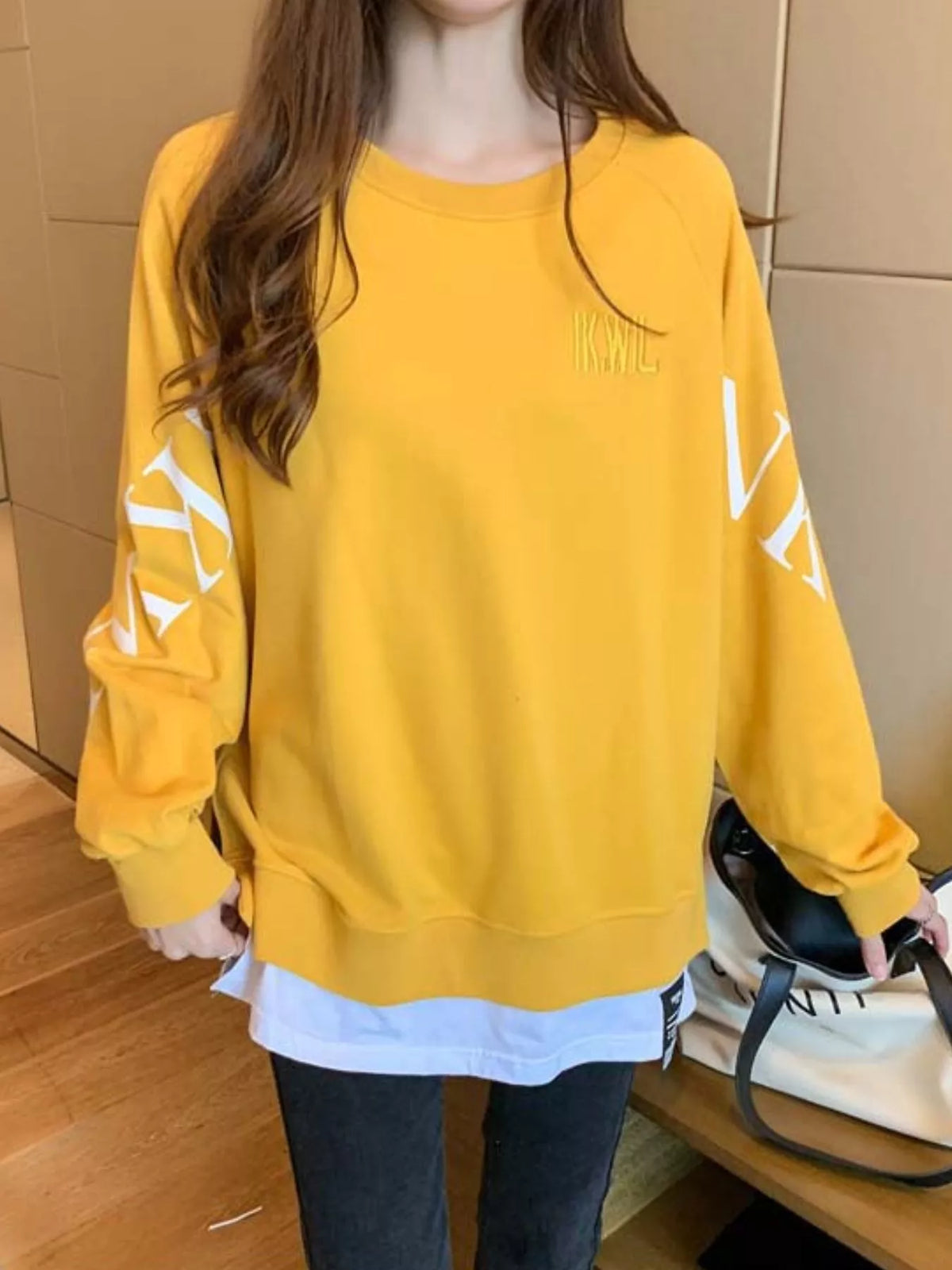 Yellow layered-hem sweatshirt with graphic sleeve detail