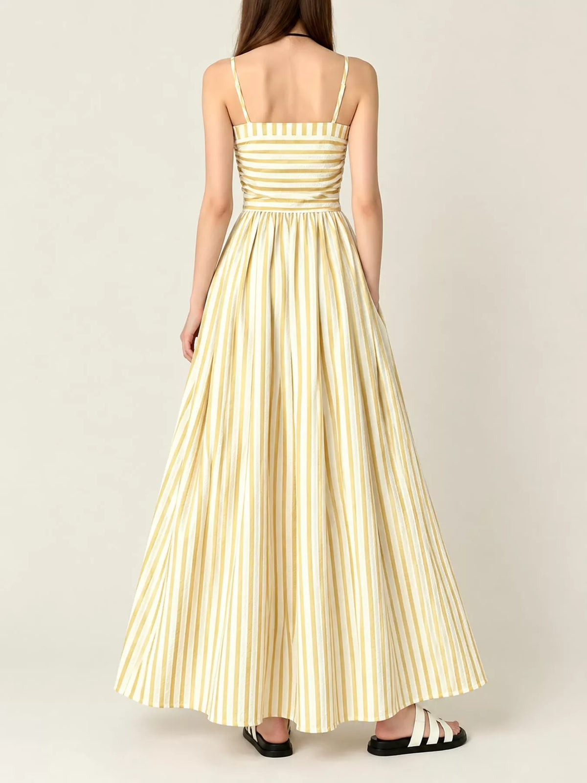 Yellow and white striped spaghetti strap maxi dress with gathered bodice and pockets, back view