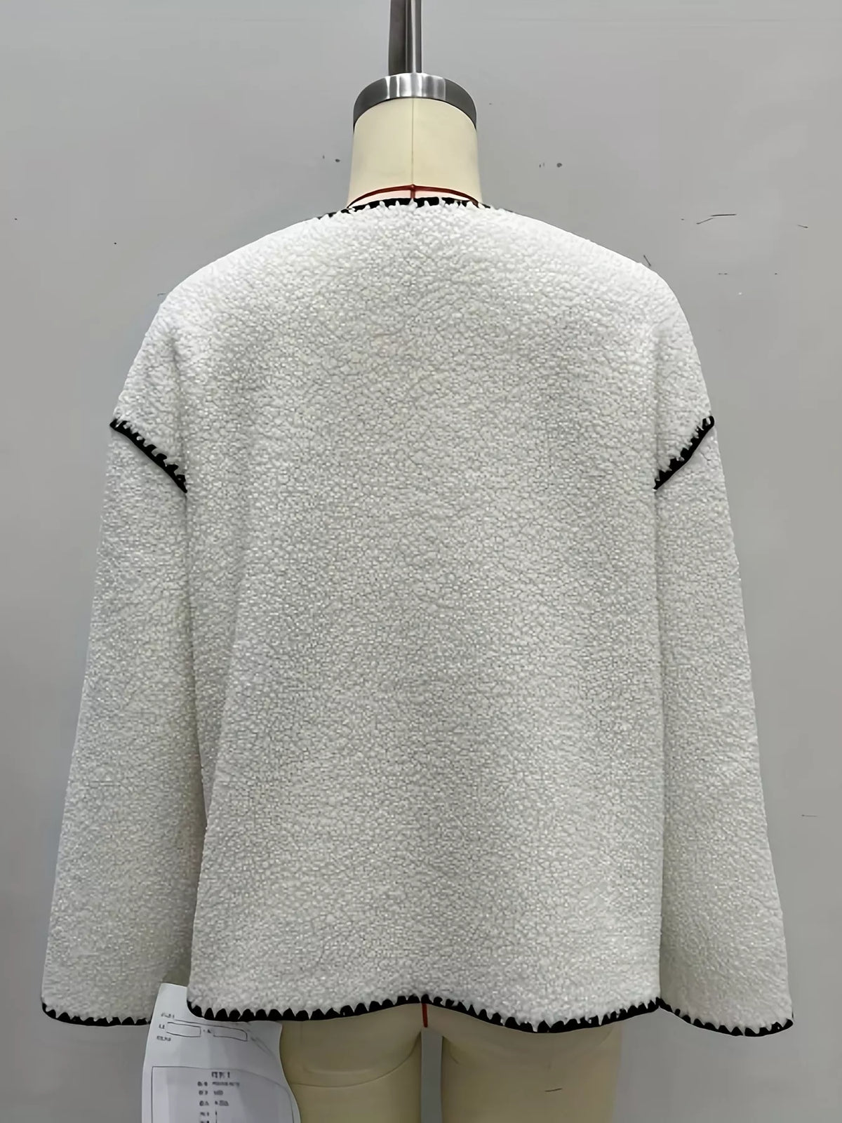 Cream with black trim faux shearling contrast trim button-down jacket, back view