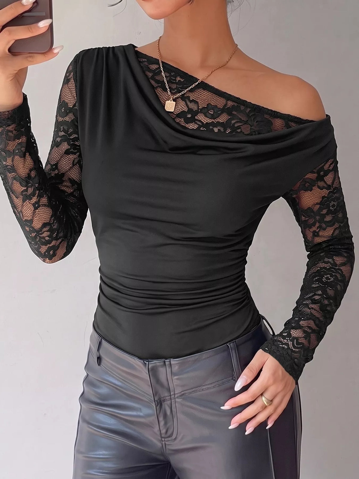 Black lace-sleeve draped bodysuit