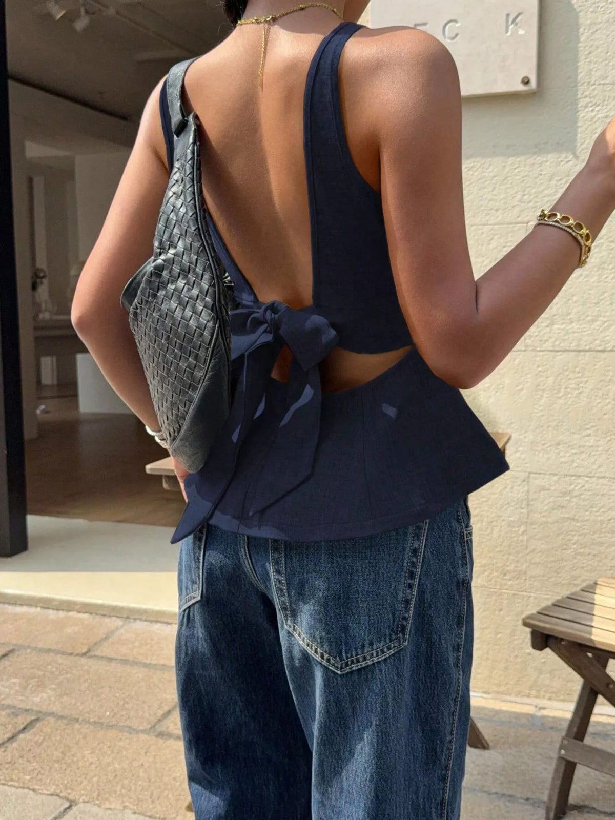 Navy open-back bow-tie peplum tank top, open back and bow tie view.