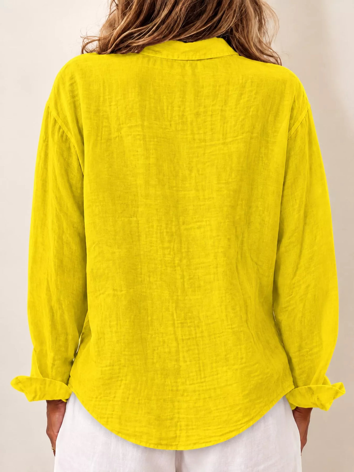 Yellow asymmetric button-down long sleeve shirt, back view
