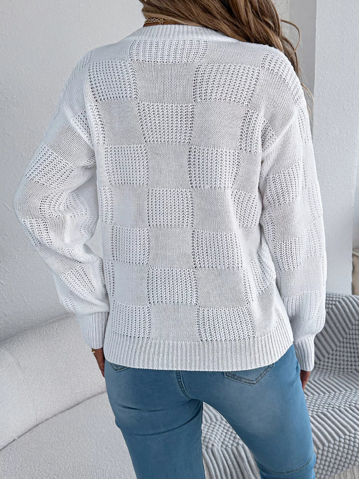 White checkerboard textured knit sweater, back view