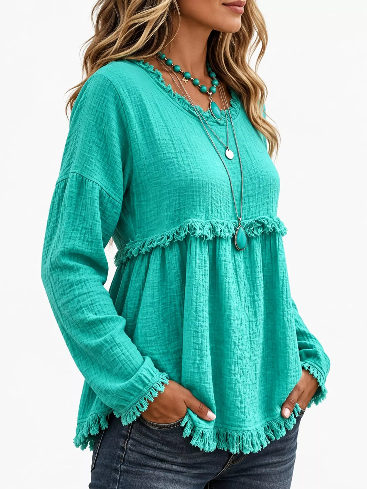 Teal frayed hem textured blouse, side view
