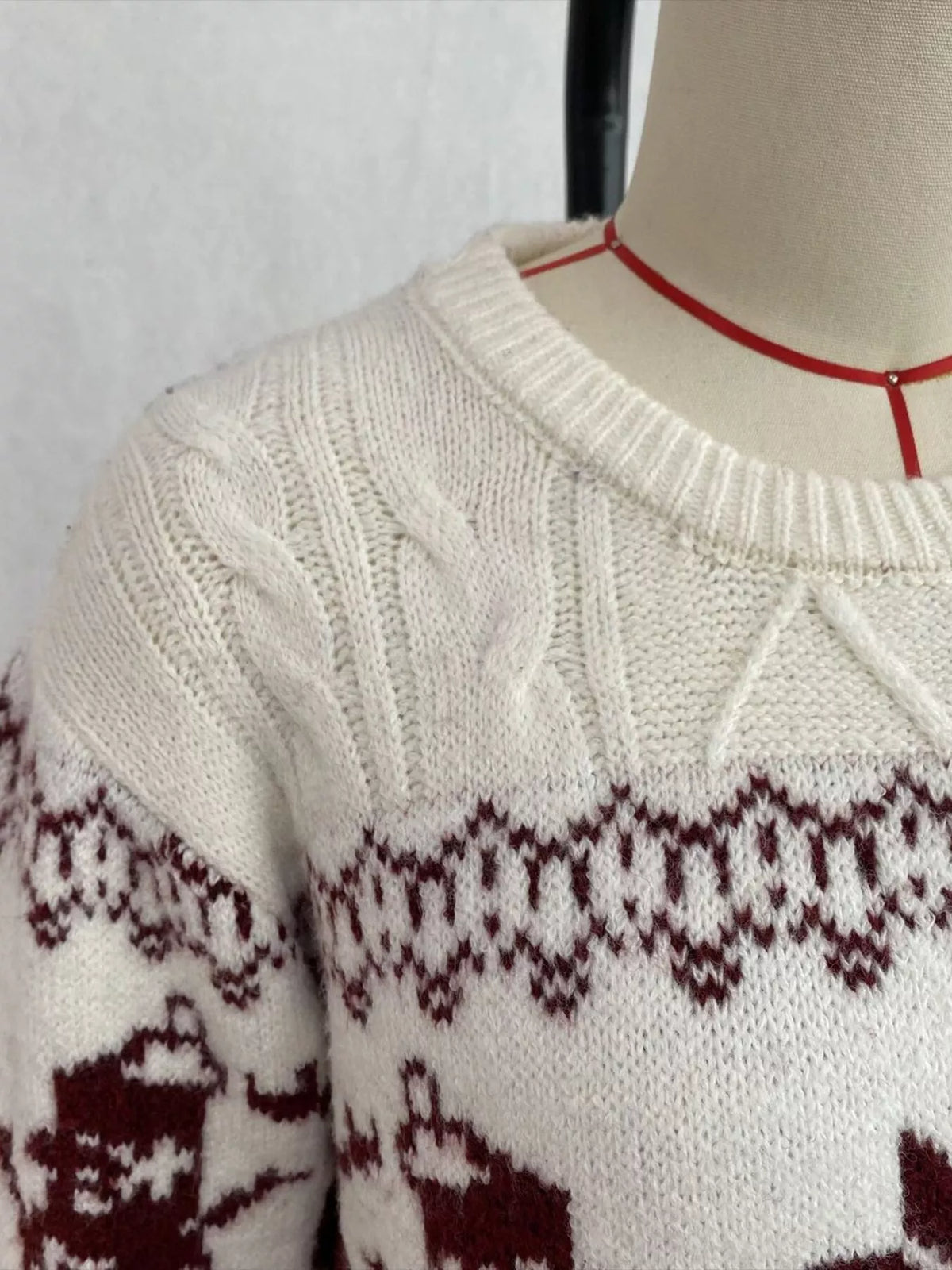 Ivory christmas snowman cable-knit sweater, neckline and snowman knit detail.