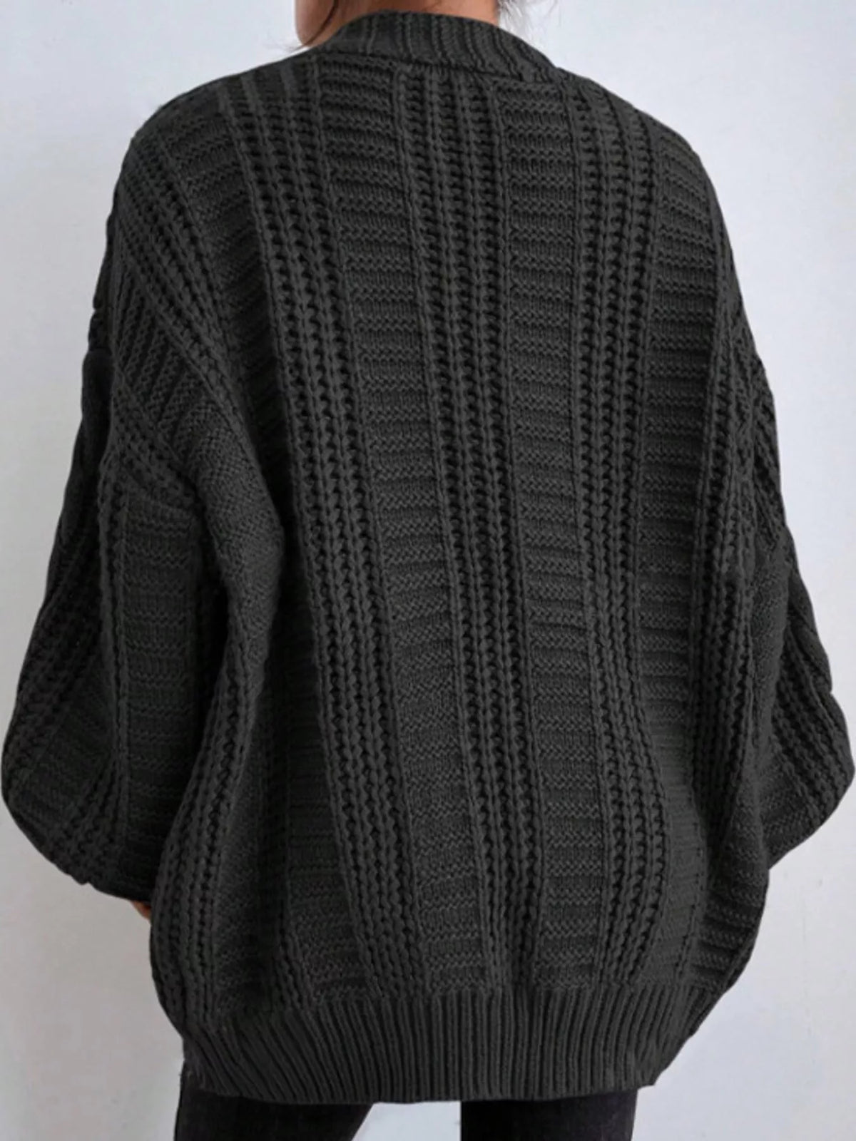Black cable knit button-down cardigan, back view
