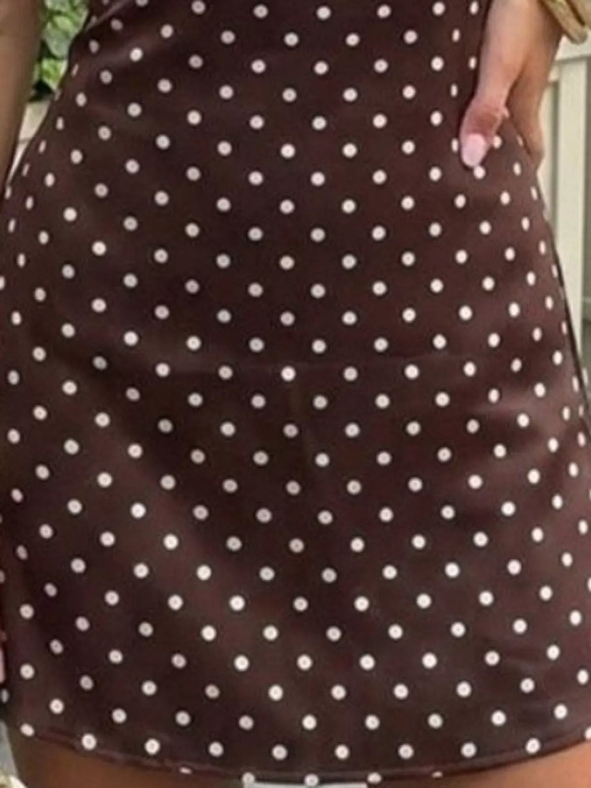 Brown and white polka dot halter neck mini dress, detail view