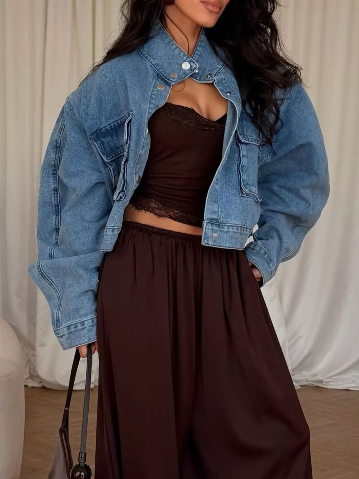 Blue oversized cropped denim utility jacket, angled front view.