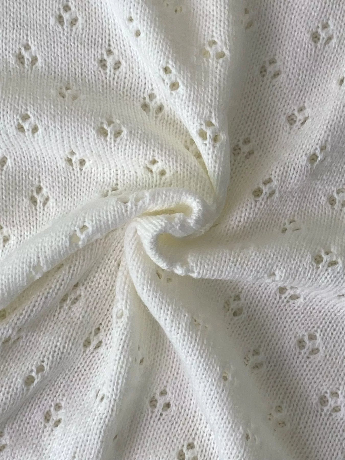 White pointelle round-neck knit top, pointelle knit close-up.
