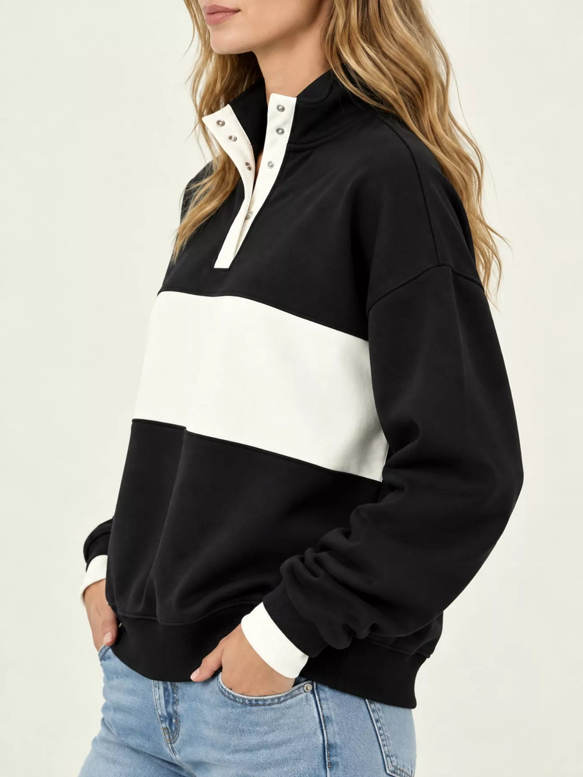 Black and cream color block snap-button sweatshirt, side view