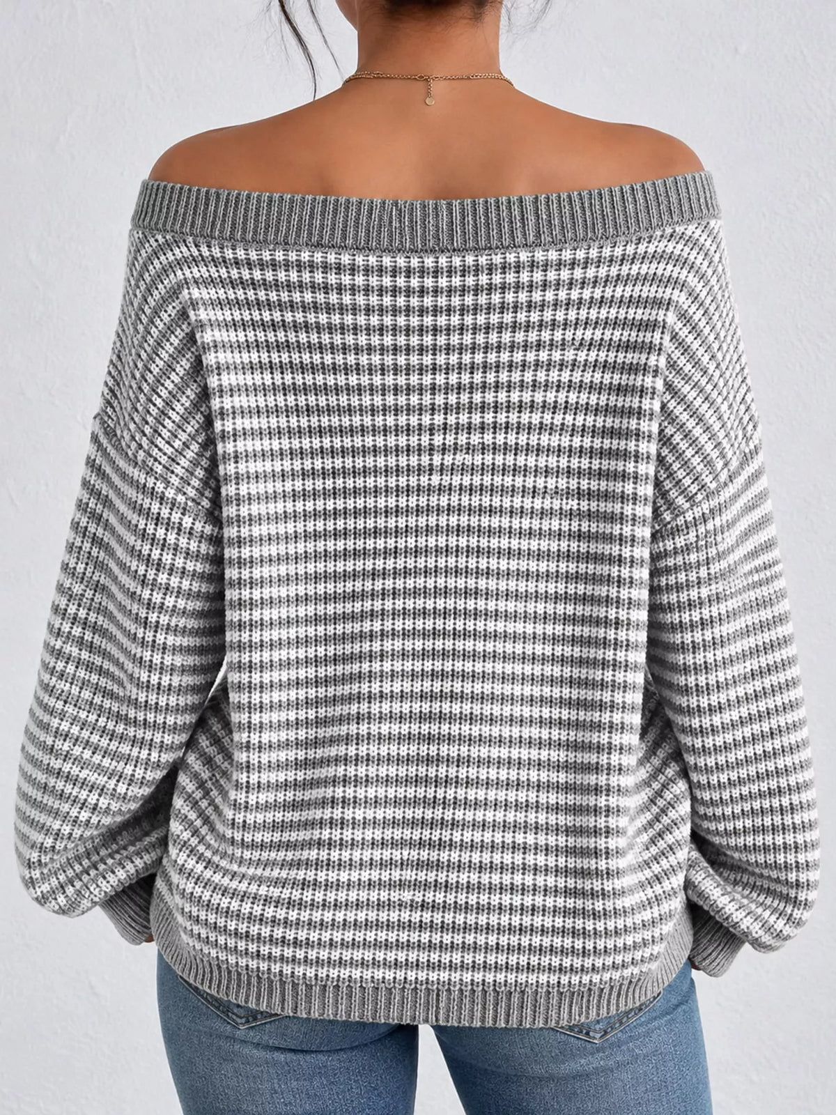 Gray and white striped knit boat neck sweater, back view