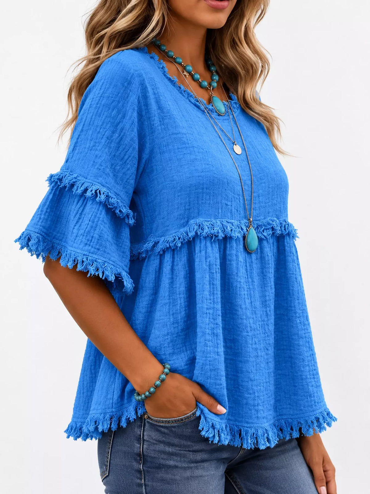 Blue frayed edge textured blouse, side view