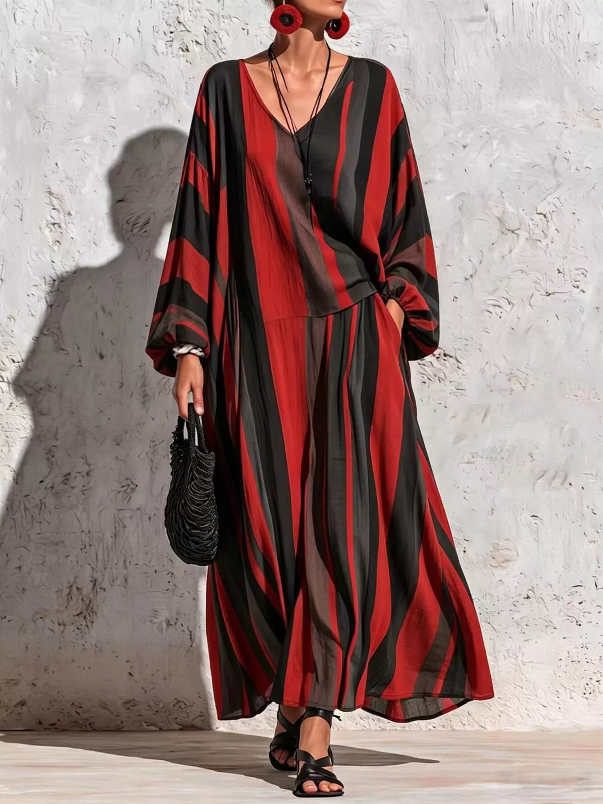 Red and black striped v-neck top and wide-leg pants set, front view with hand at hip.