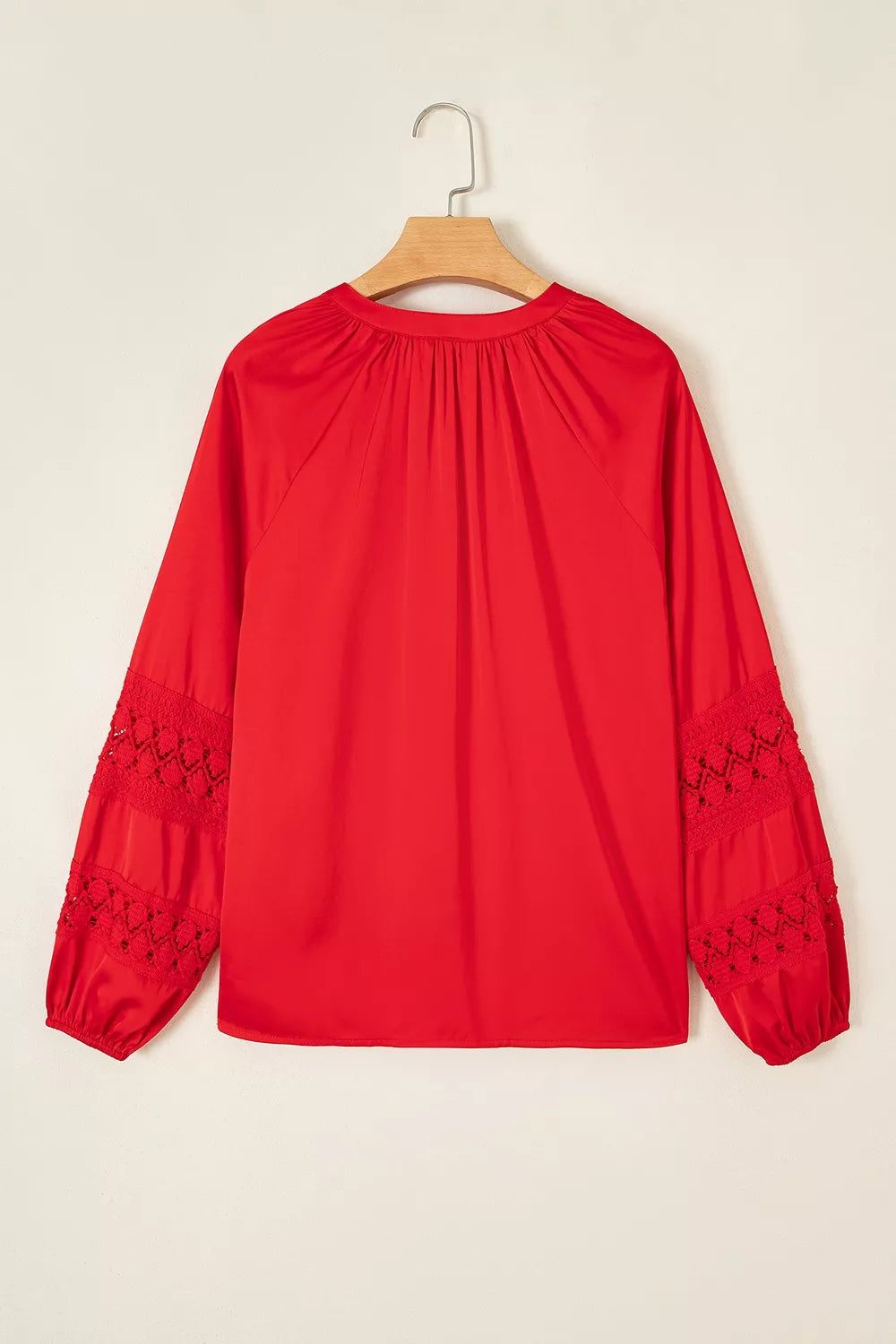 Red lace-panel v-neck button-front shirt, back on hanger.