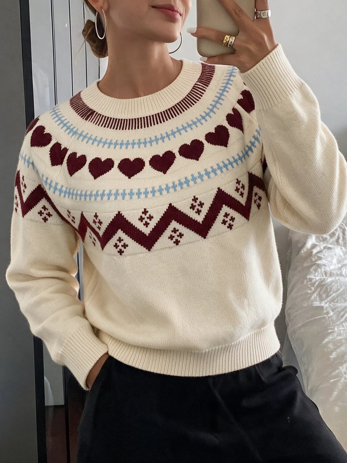 Cream heart-patterned crew neck sweater, neckline and hem view