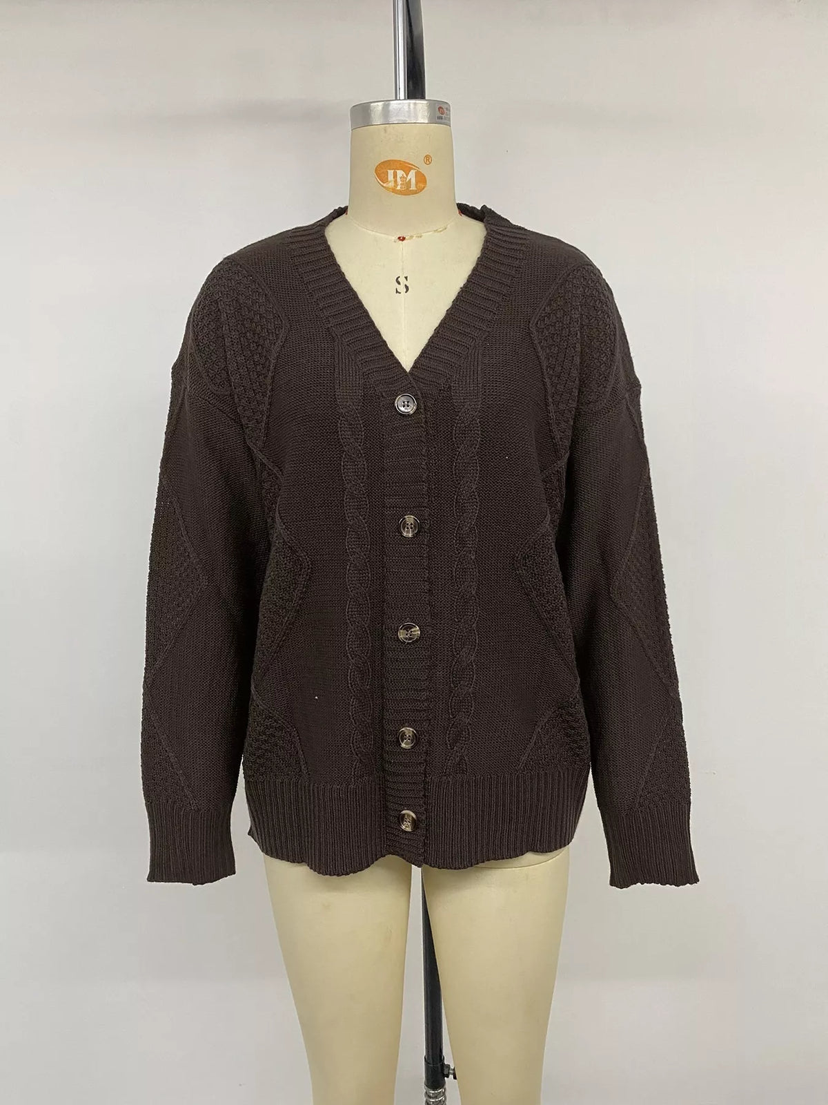 Brown V-neck cable knit cardigan, front on mannequin