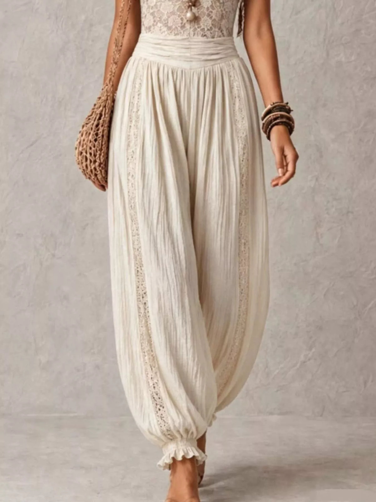 Ivory lace-bodice harem-leg jumpsuit, harem pants detail.
