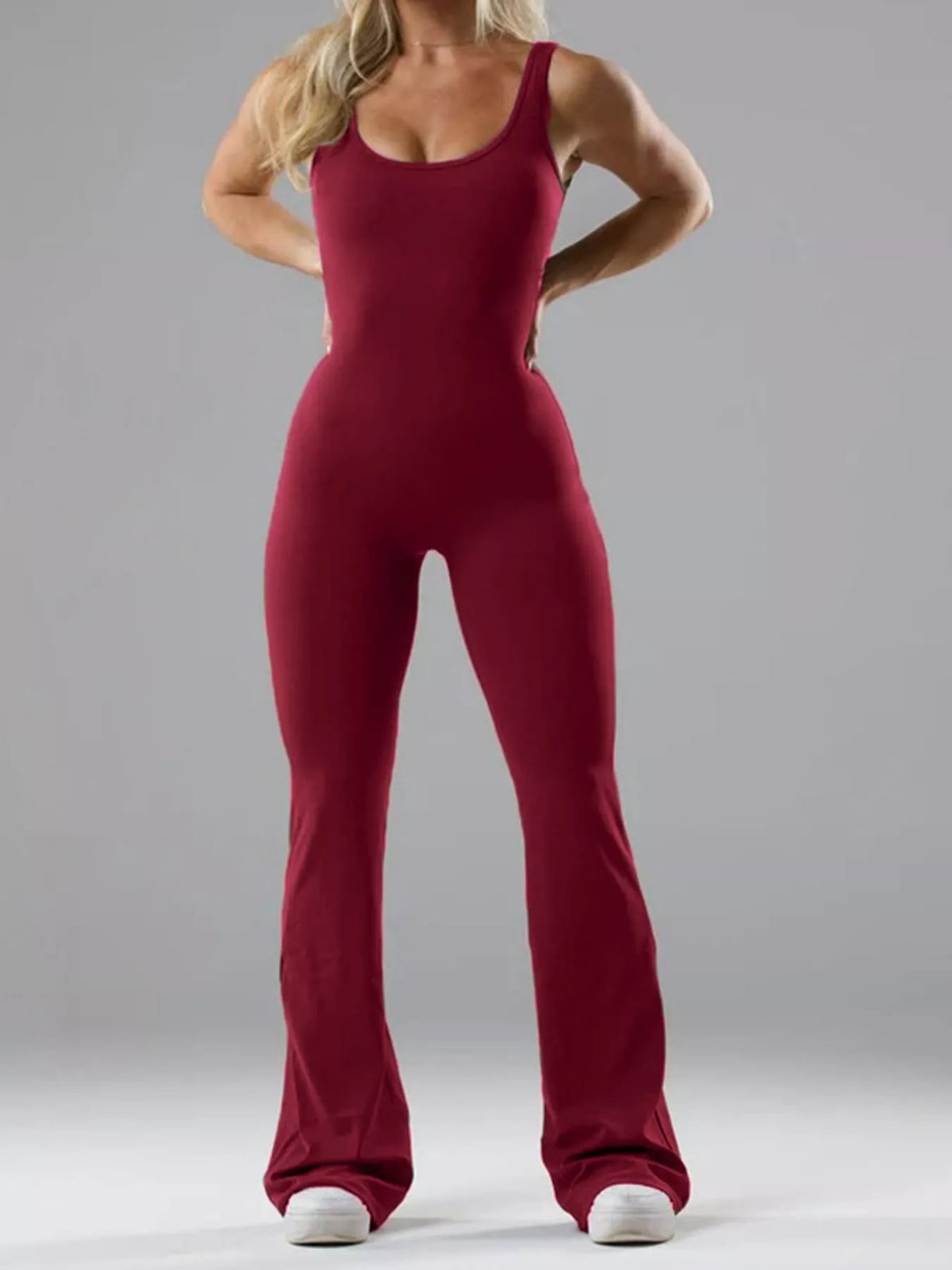 Burgundy scoop-neck flared-leg active jumpsuit, full front view.