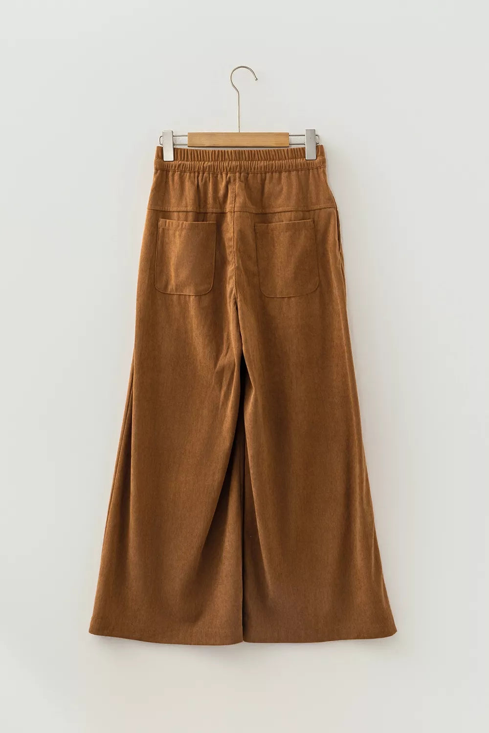 Brown button-detail wide-leg pants, back on hanger