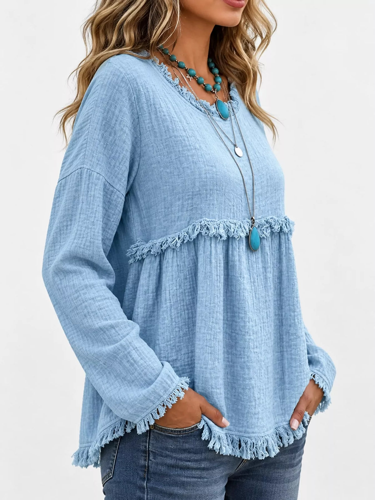 Light blue frayed hem textured blouse, side view