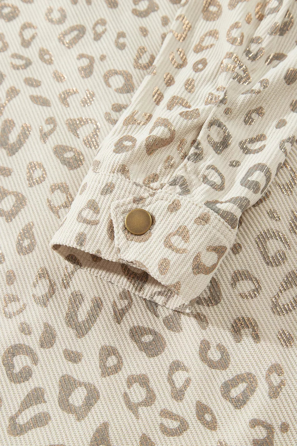 Beige leopard corduroy button-front jacket, button cuff detail.