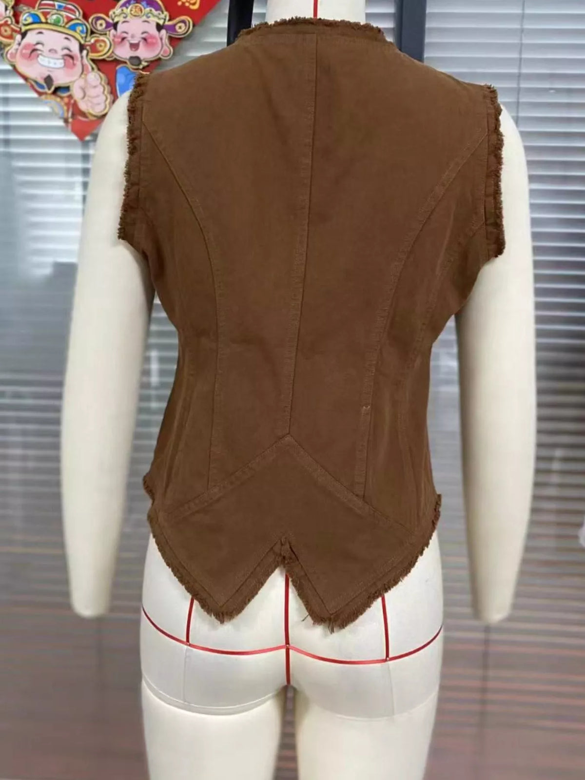 Raw hem button up vest, back view