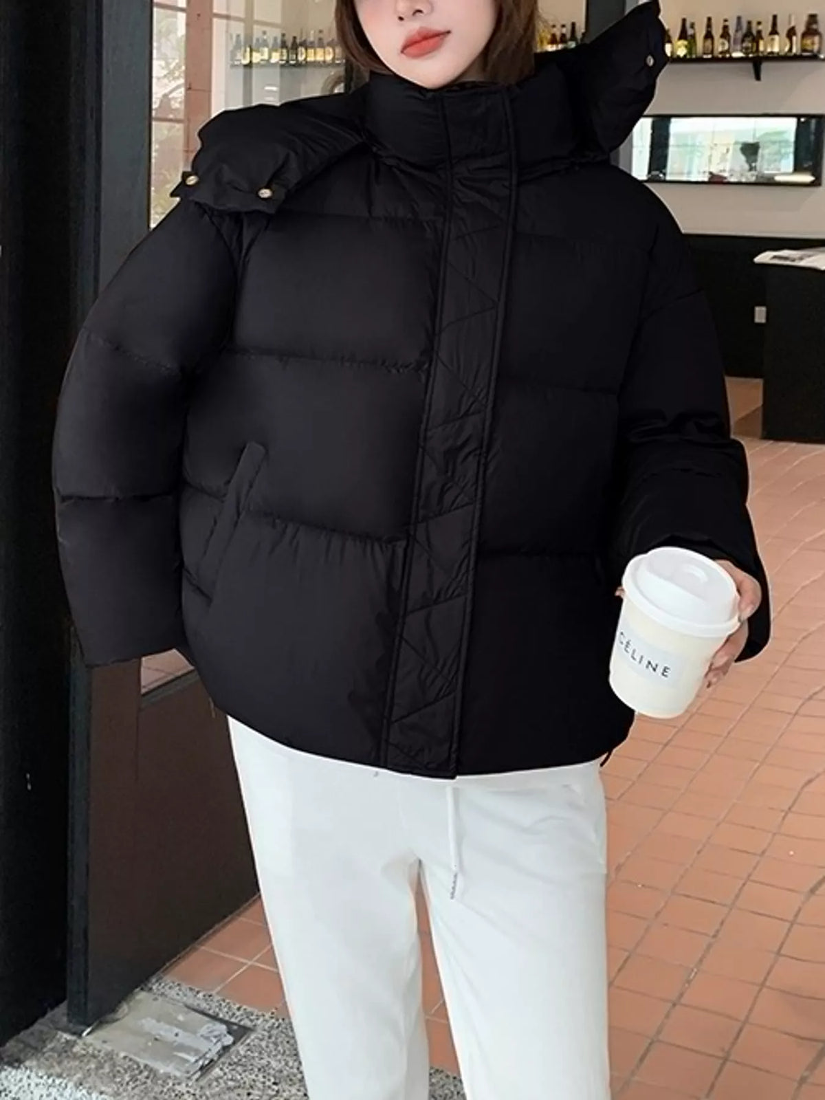 Black quilted hooded puffer jacket, front view