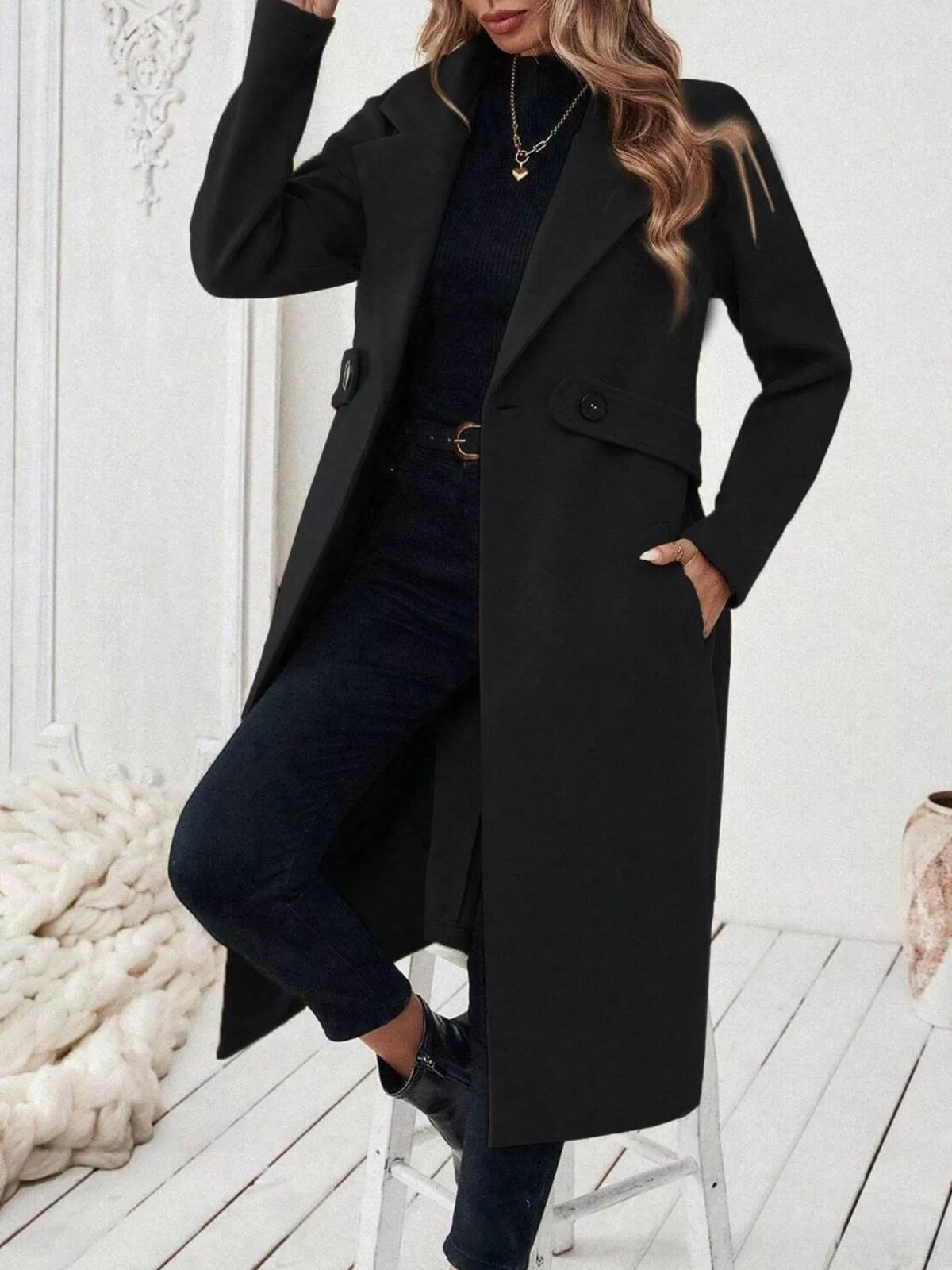 Black lapel-collar longline coat, open front, knee bent